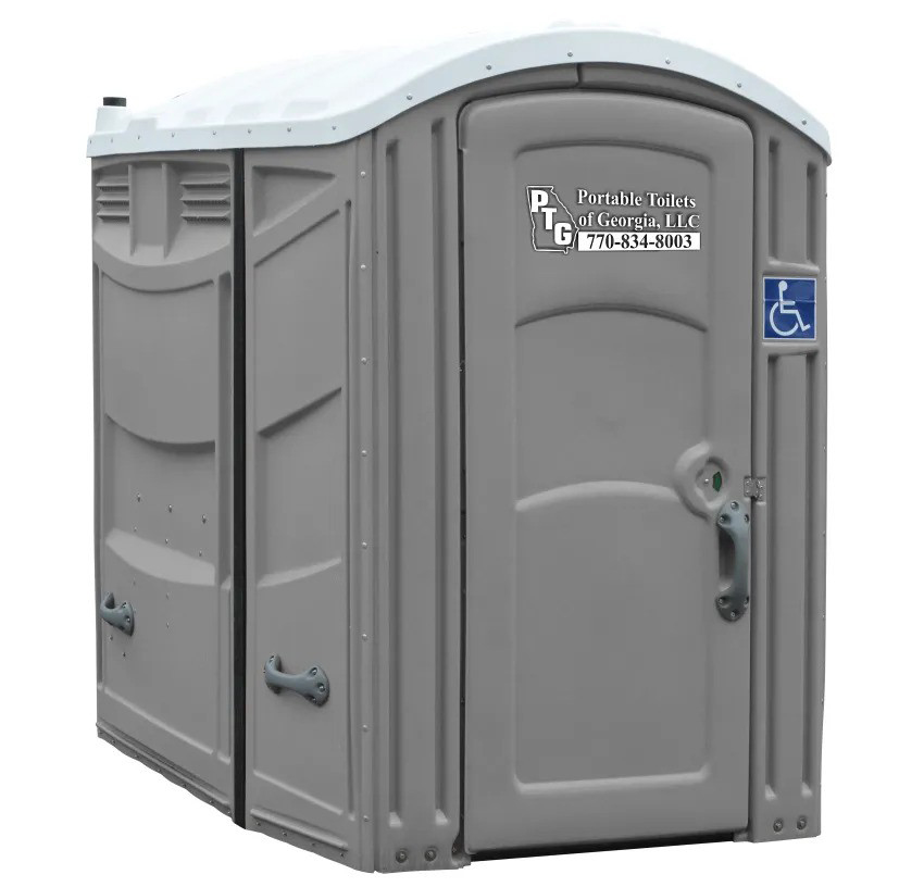 Portable Toilet featuring a gray exterior with a sign that reads Portable Toilets of Georgia, LLC and a contact number. The unit also has a handicap accessibility symbol on the door.