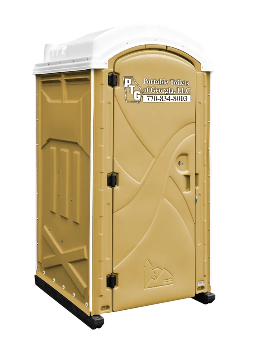 A clean, portable toilet with a beige exterior and a white roof. The door features a latch and a small lock, and the side displays the logo and contact information for Portable Toilets of Georgia, LLC. The toilet is positioned on a flat surface with visible supports at the base.